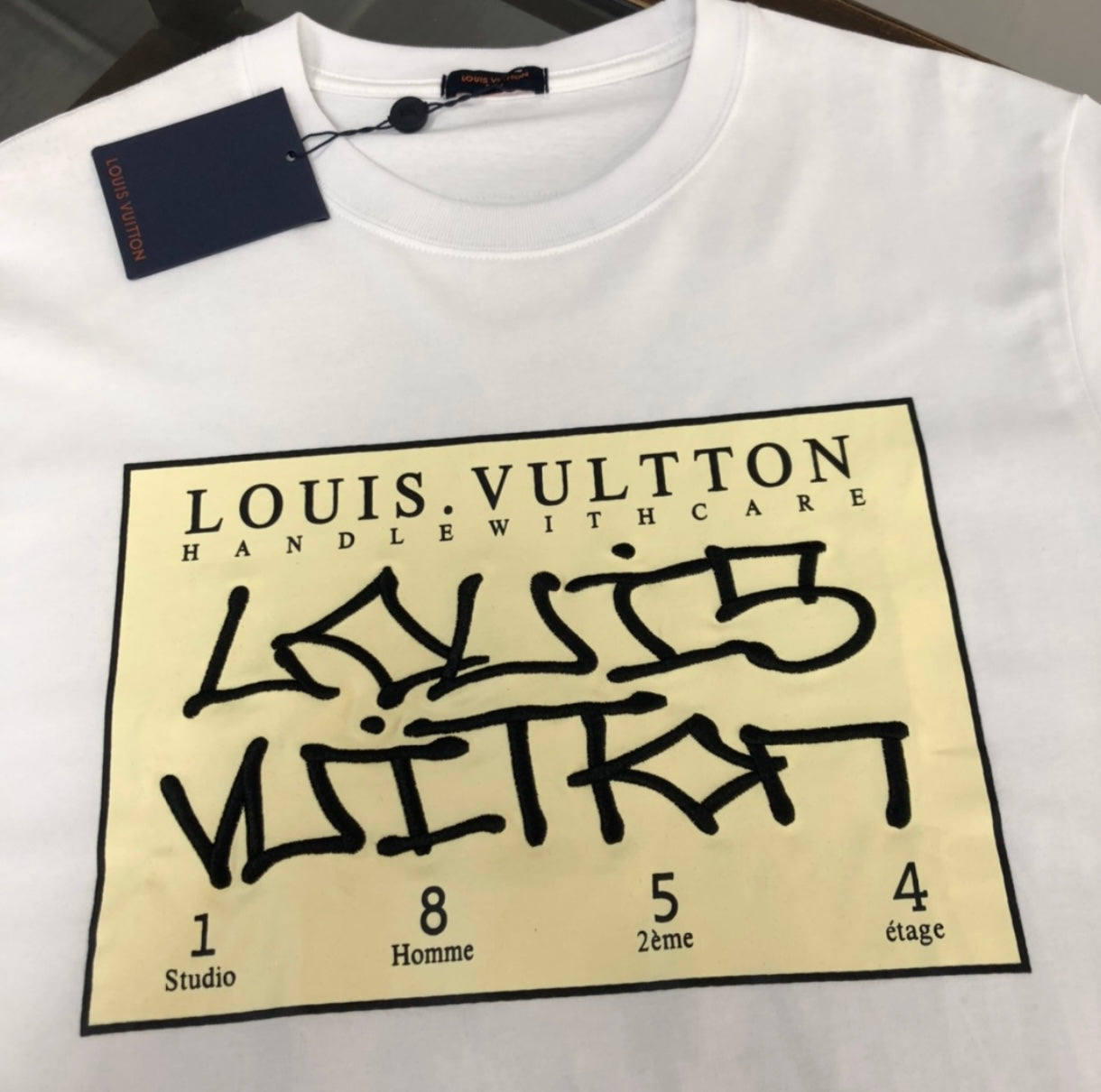 Louis Vuitton “HANDLE WITH CARE” WHITE